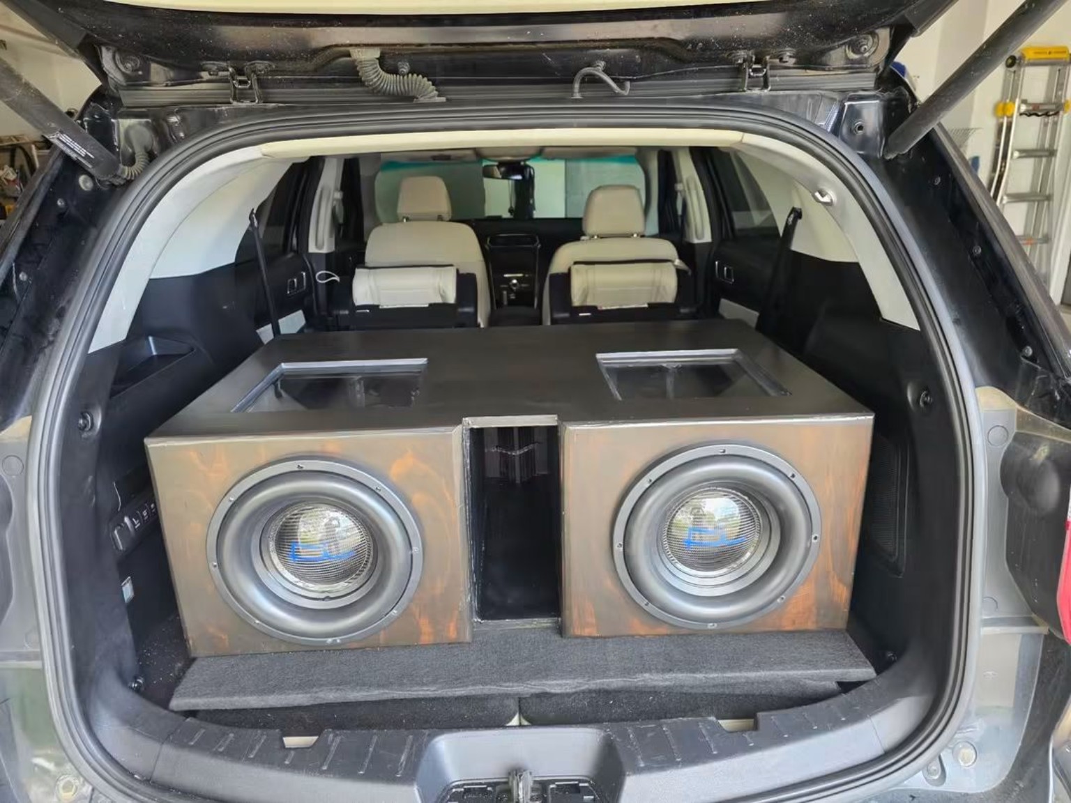 Dual-subwoofer enclosure installed in a hatchback